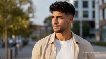 A young man with low fade haircut wearing shirt.