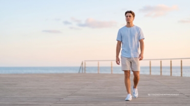 Stylish man wearing sneakers for men on a beach side