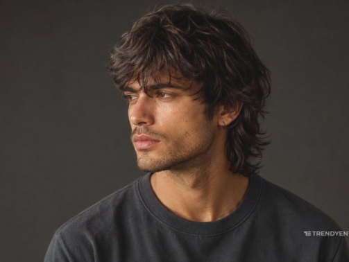 Close up potrait of a stylish boy showing difference between wolf cut vs mullet